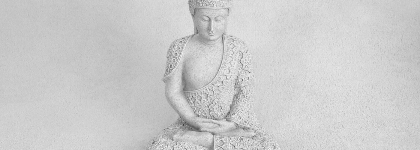 A person meditating outdoors with calm, slow breathing in a peaceful natural setting.
