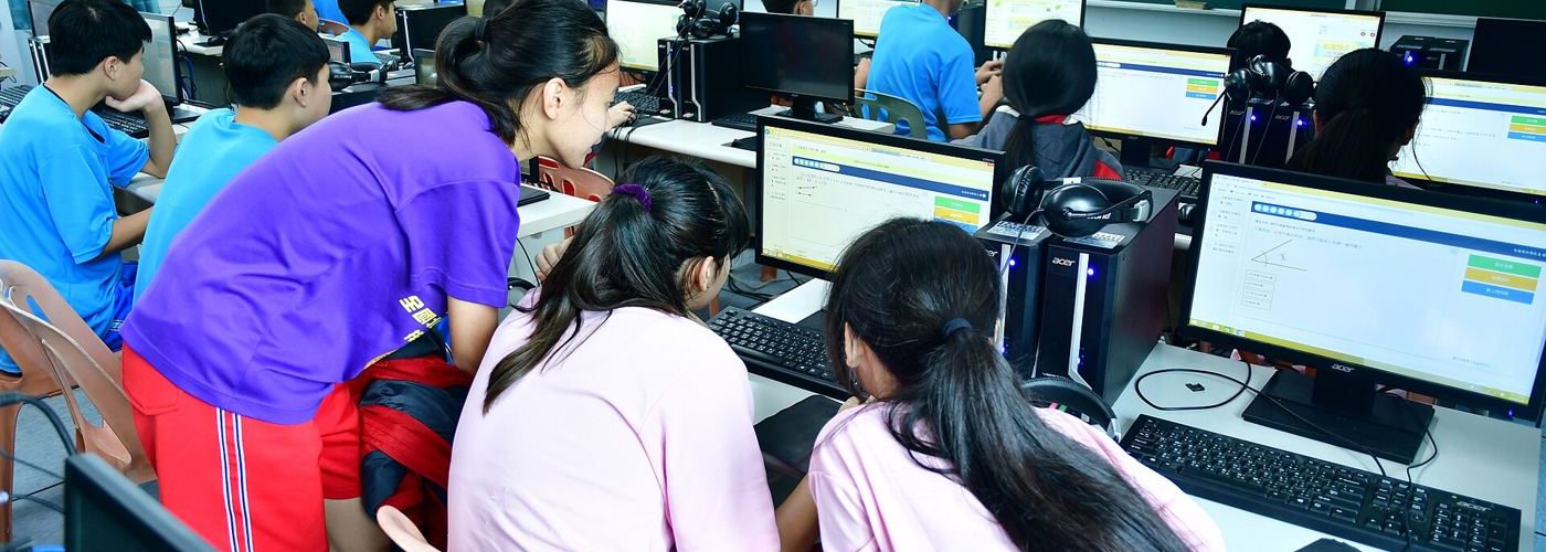adults in a training classroom using computers