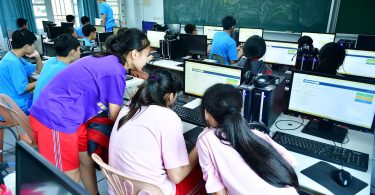 adults in a training classroom using computers