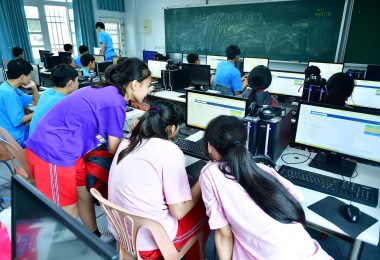 adults in a training classroom using computers