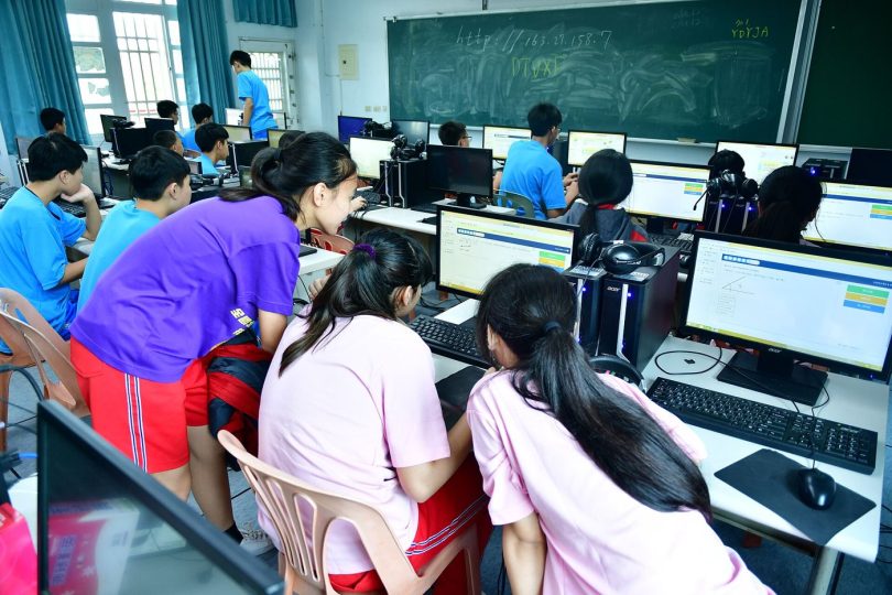 adults in a training classroom using computers