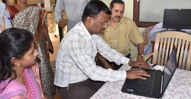 adults in a training classroom using computers