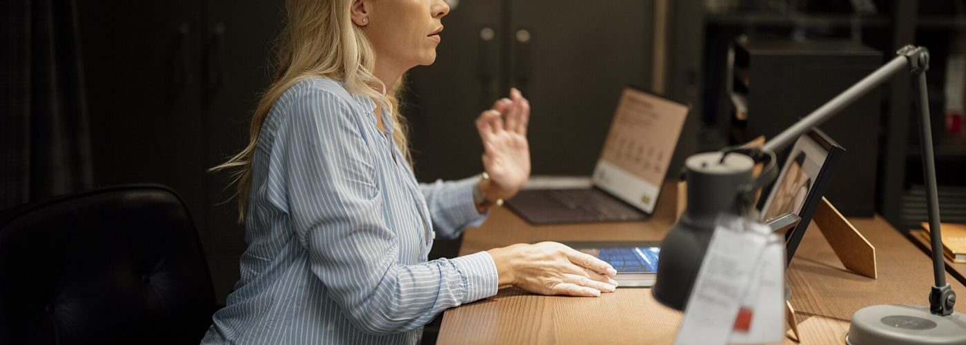 Hands typing on a keyboard at a desk